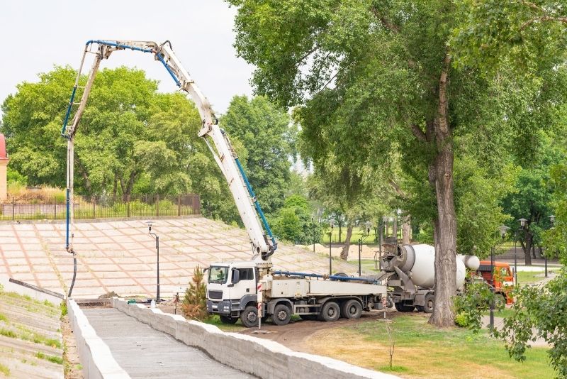 a concrete mixer pouring concrete on the driveway