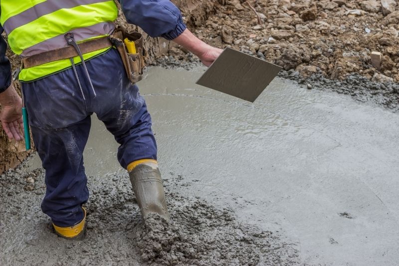 a conrete builder on boots walking on the concrete mix