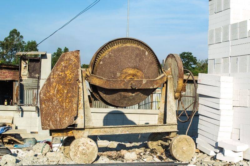 an old looking concrete mixer showing some rust on it
