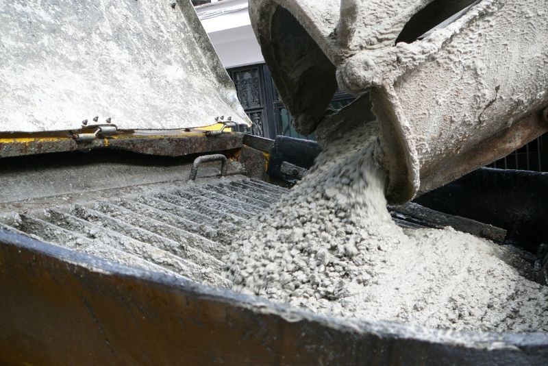 pouring a concrete from a huge concrete mixer
