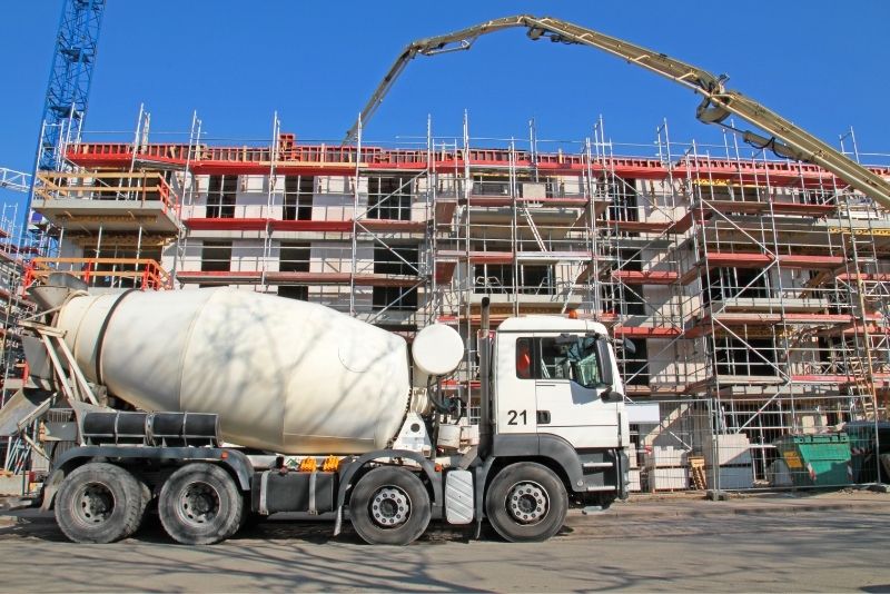 concrete mixer infront of building under construction